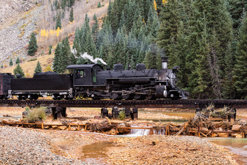 Vintage Steam Train Crossing a River in Colorado