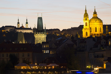 Fototapeta na wymiar Prague St. Nicholas' Cathedral with the Lesser Town above River Vltava in the Night, Czech Republic