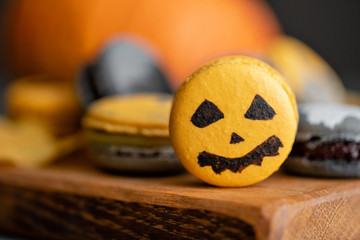 Halloween scary cookies with pumpkin on wooden cut board. pattern Bat , patina, ghosts and spiders. Gray color background,