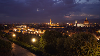 Scenic nighttime city view of Florence in the evening with bright city lights