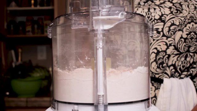 Woman blending flour mixing in food processer, Close Up