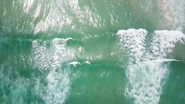 aerial view waves and surfers