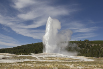 Erupting Old Faithful Geyser in Yellowstone National Park, Wyoming USA