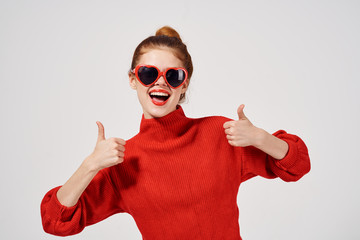 joyful woman in glasses shows thumbs up smile