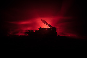 Sea battle scene. Silhouette of military war ship on dark foggy toned sky background. Explosion and...