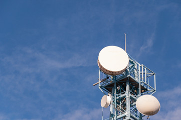 A telecommunications tower against a background of blue sky