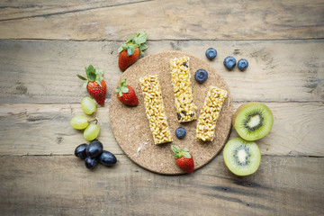 Fresh fruits with granola bars on the table