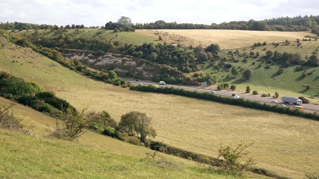 Traffic on motorway in hilly countryside