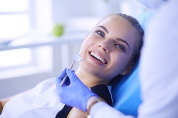 Young Female patient with pretty smile examining dental inspection at dentist office. - 226132520