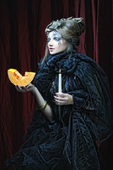 Gothic portrait of woman with candle. 