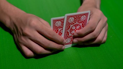 Player anxiously waiting for his turn to reveal his good hand of pair king on a poker table in 4K