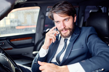 luxury business man talking on the phone sitting in the car