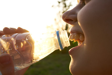 thirsty woman drinking water on nature summer
