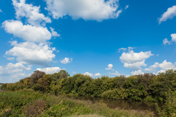 Fototapeta na wymiar Zyuzelga river under the blue summer sky