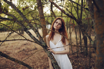 beautiful woman in white dress near the tree summer nature