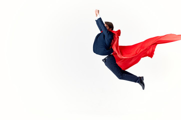 businessman in red coat jumping on white isolated hero background