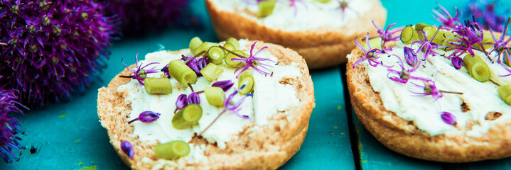 Closeup of flowering chives with shallow depth of field and focus concentrated on flower in the foreground