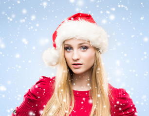 Young and beautiful girl in a Christmas hat. Winter concept.