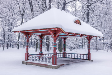 Bower in city park covered by snow 