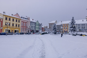 Square during first winter snow in city Valasske Mezirici covered fully in snow