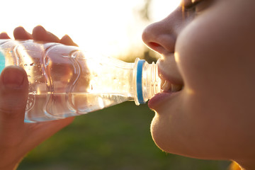 woman drinking water in nature