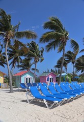 Colorful cabanas and lounge chairs on the beach in Princess Cays