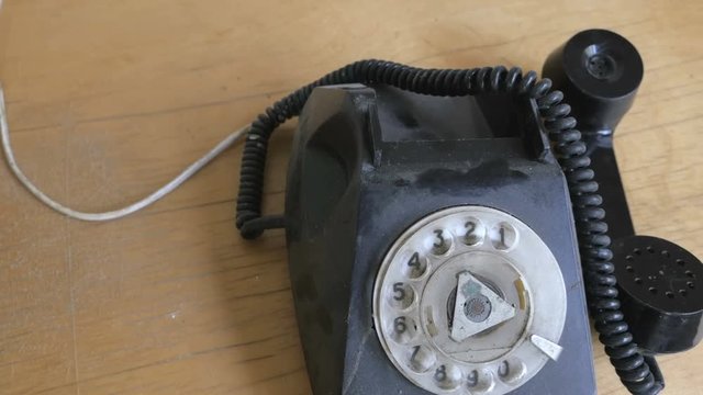 Retro rotary telephone is covered dusty. Concept: 70s, 80s. Camera flying
