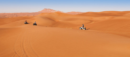 Fototapeta na wymiar desert safari experience with atv 4x4 vehicles