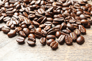 Roasted coffee beans on wooden background, closeup