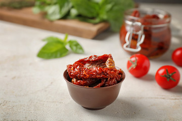 Dried tomatoes in bowl on table. Healthy snack