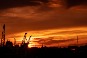 Silhouette of construction site with sunset sky