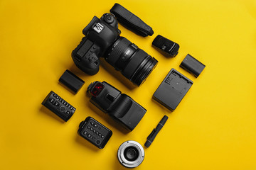 Flat lay composition with photographer's equipment and accessories on color background