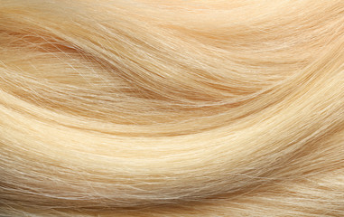 Texture of healthy blond hair as background, closeup