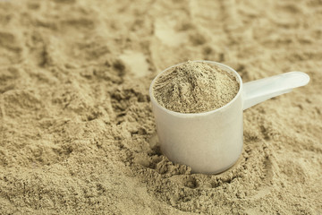 Measuring spoon and hemp protein powder, closeup. Superfood