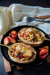 Autumn food with fresh vegetables, quick lunch: eggplant stuffed with tomatoes and cheese. The concept of healthy and vegetarian food.
