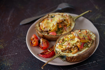 Autumn food with fresh vegetables, quick lunch: eggplant stuffed with tomatoes and cheese. The concept of healthy and vegetarian food.