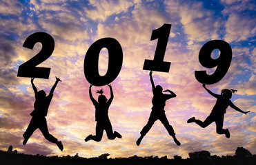 Silhouette sunset background and New year.They are jumping in to sky and lift  2019 word. They are happy and fun, activity,out door, Photo Silhouette and new year  concept idea.