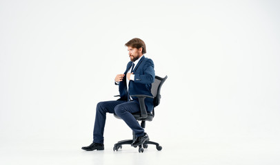 business man sitting on a chair straightening his jacket