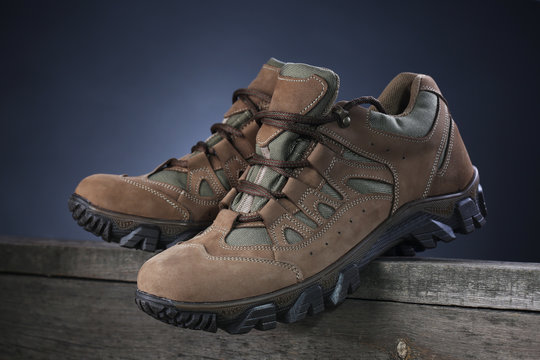 Hiking boots on wooden background