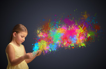 Cute little girl using tablet with colourful splash concept
