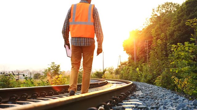 Inspector (engineer) checks the work of the railway construction in the west