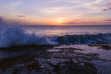 sunset on the beach with crashing wave