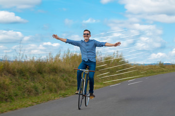 Casual hipster cyclist riding bicycle with high speed concept