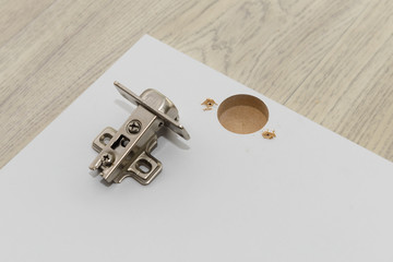 urniture hinge and facade made of MDF with a hole for the hinge