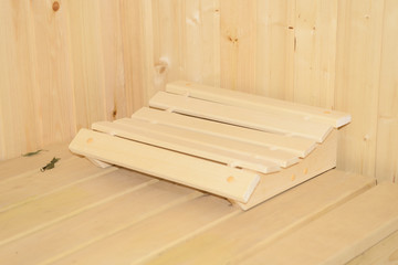 Obraz na płótnie Canvas wooden headrest made of linden on the shelf in the sauna