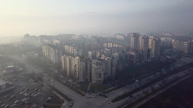 Flying over a concrete living apartment area in east Europa with many birds flying around the drone