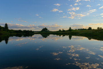 reflection of clouds in the lake at sunset of the day