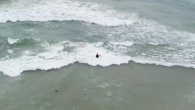 surfer going into waves