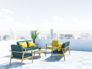 Green sofas and armchairs on balcony, cityscape