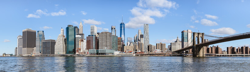 skyline of lower Manhattan and Brooklyn bridge with panoramic view on the buildings, monuments and skyscrapers - Powered by Adobe